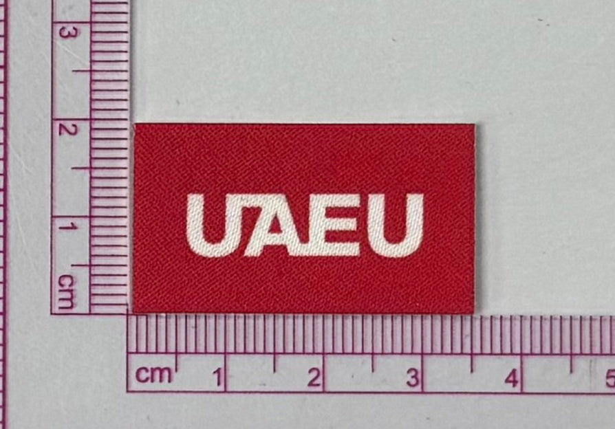 UAEU Red Patch – University Initials - with ruler for scale