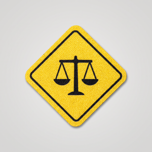 Yellow road sign patch with scales of justice icon