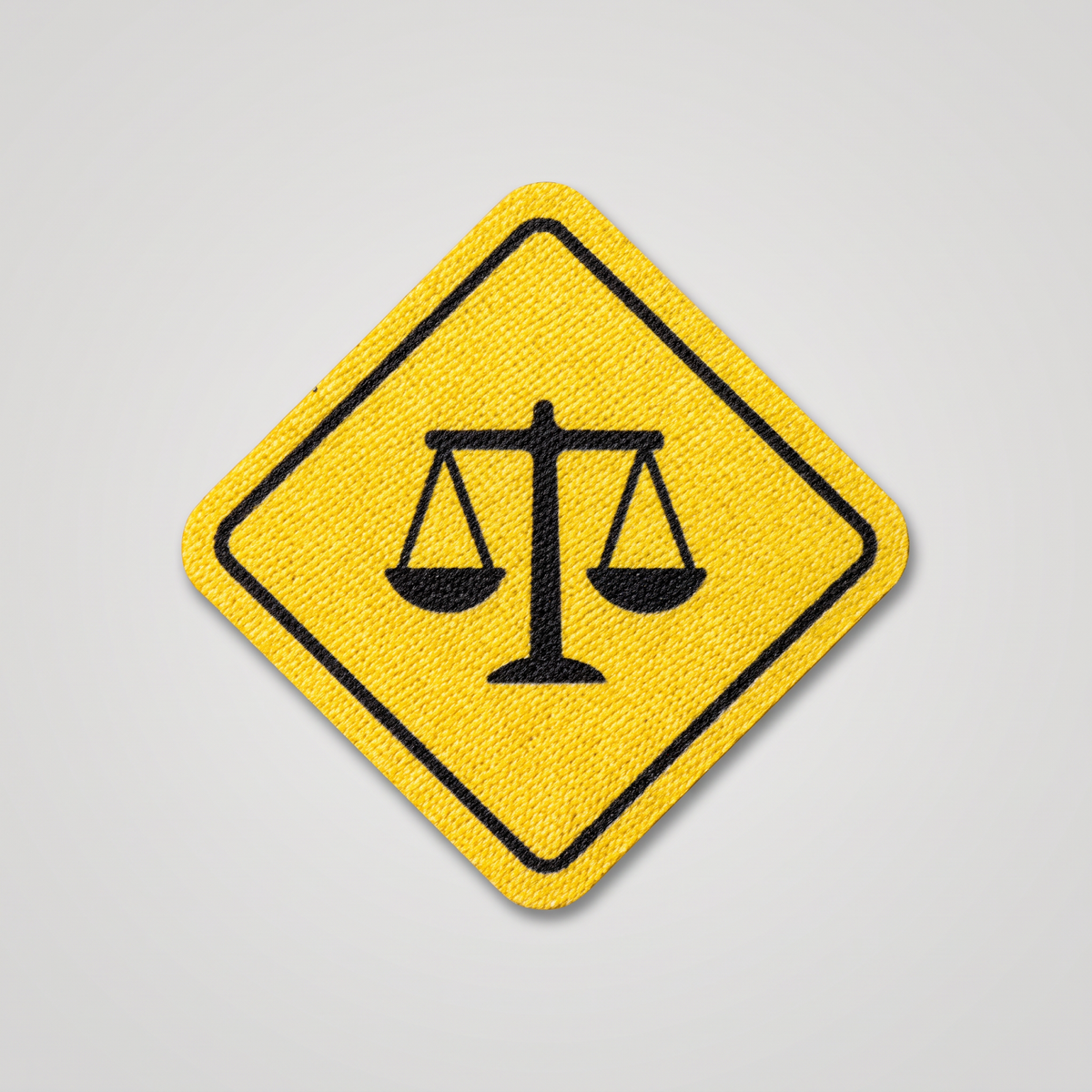 Yellow road sign patch with scales of justice icon