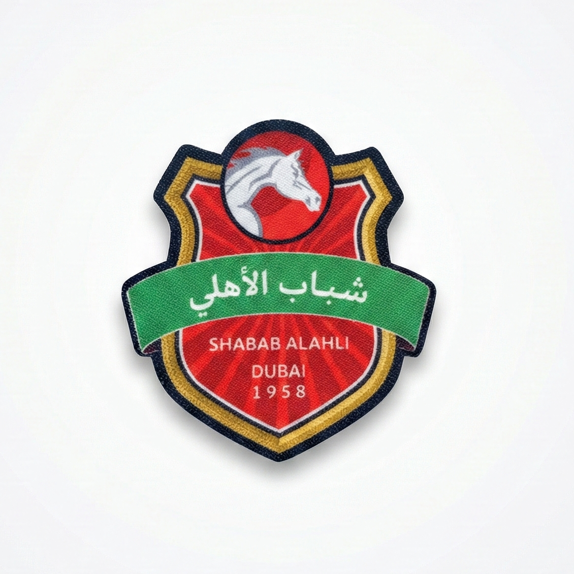 Emblem of Shabab Al Ahli Dubai with a horse on a red background