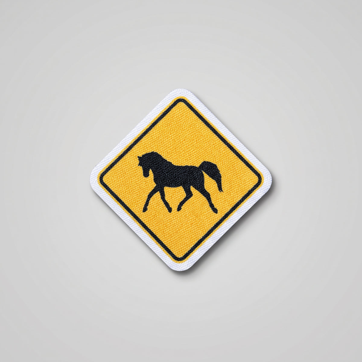 Yellow diamond road sign fabric patch with horse